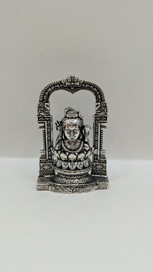 Silver Shiva murti in temple arch on lotus, front view