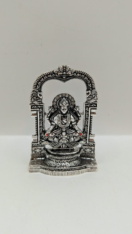 Silver Laxmi murti in temple arch, front view
