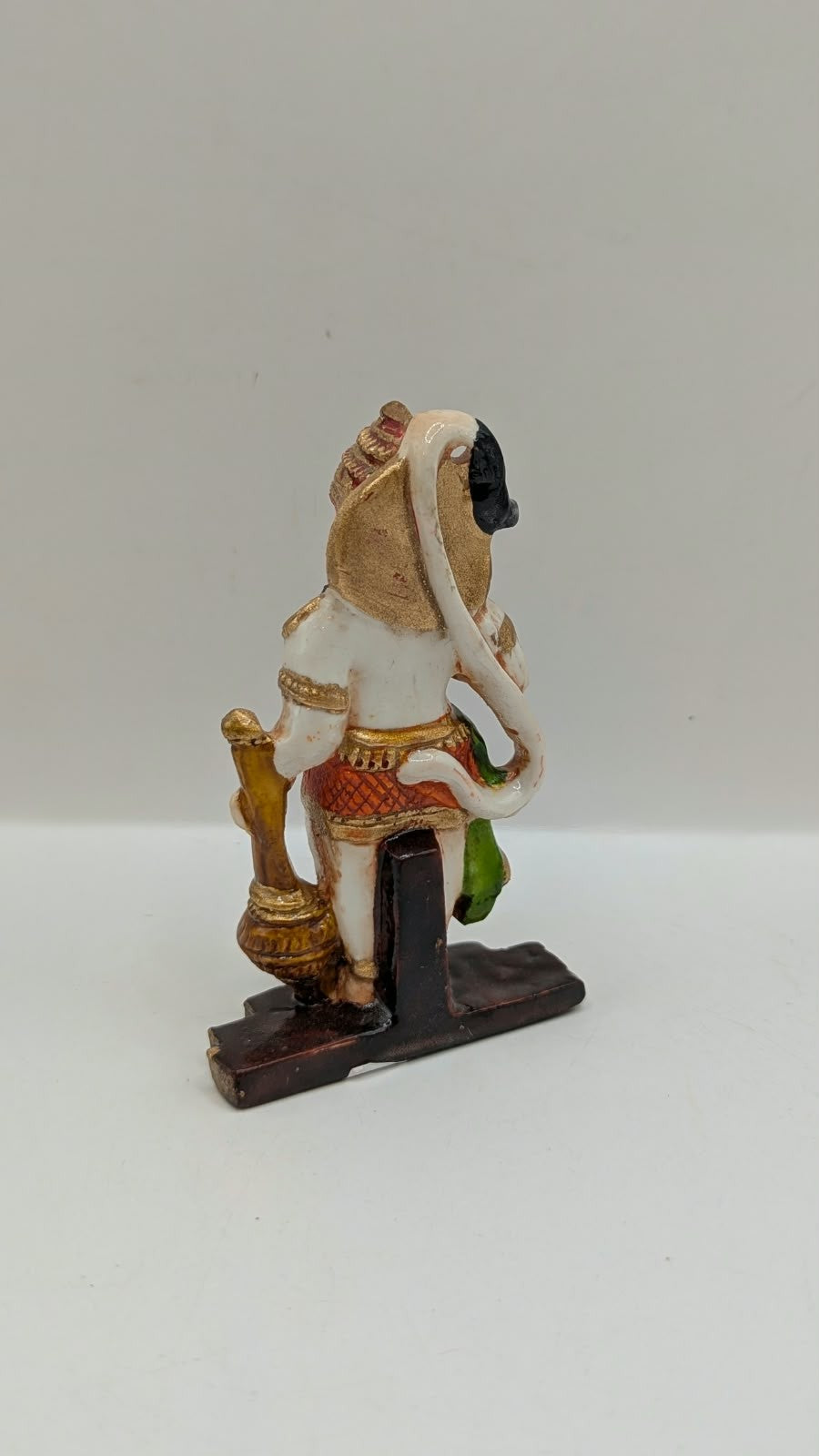 Green and orange standing Hanuman resin statue, back view