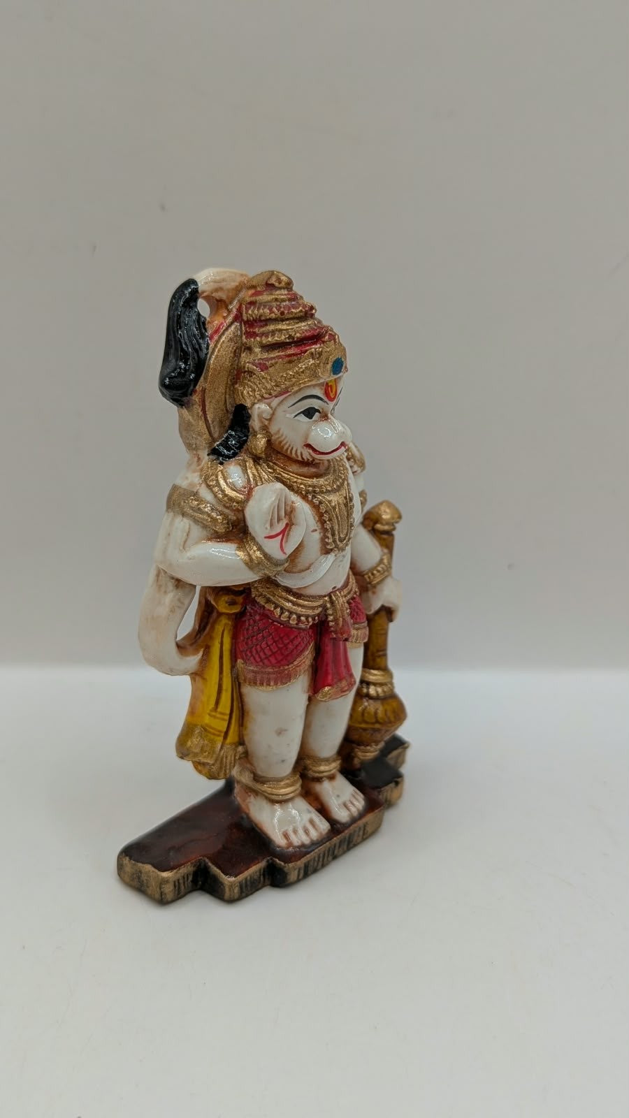 Red and gold standing Hanuman resin statue, side view