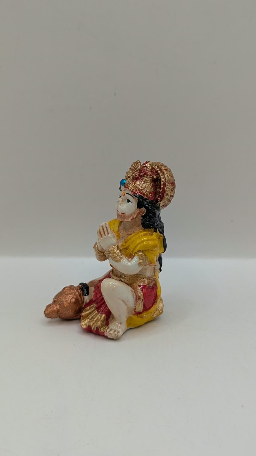Yellow and red praying Hanuman resin statue, other side view