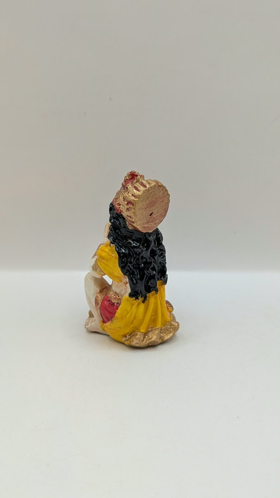 Yellow and red praying Hanuman resin statue, back view