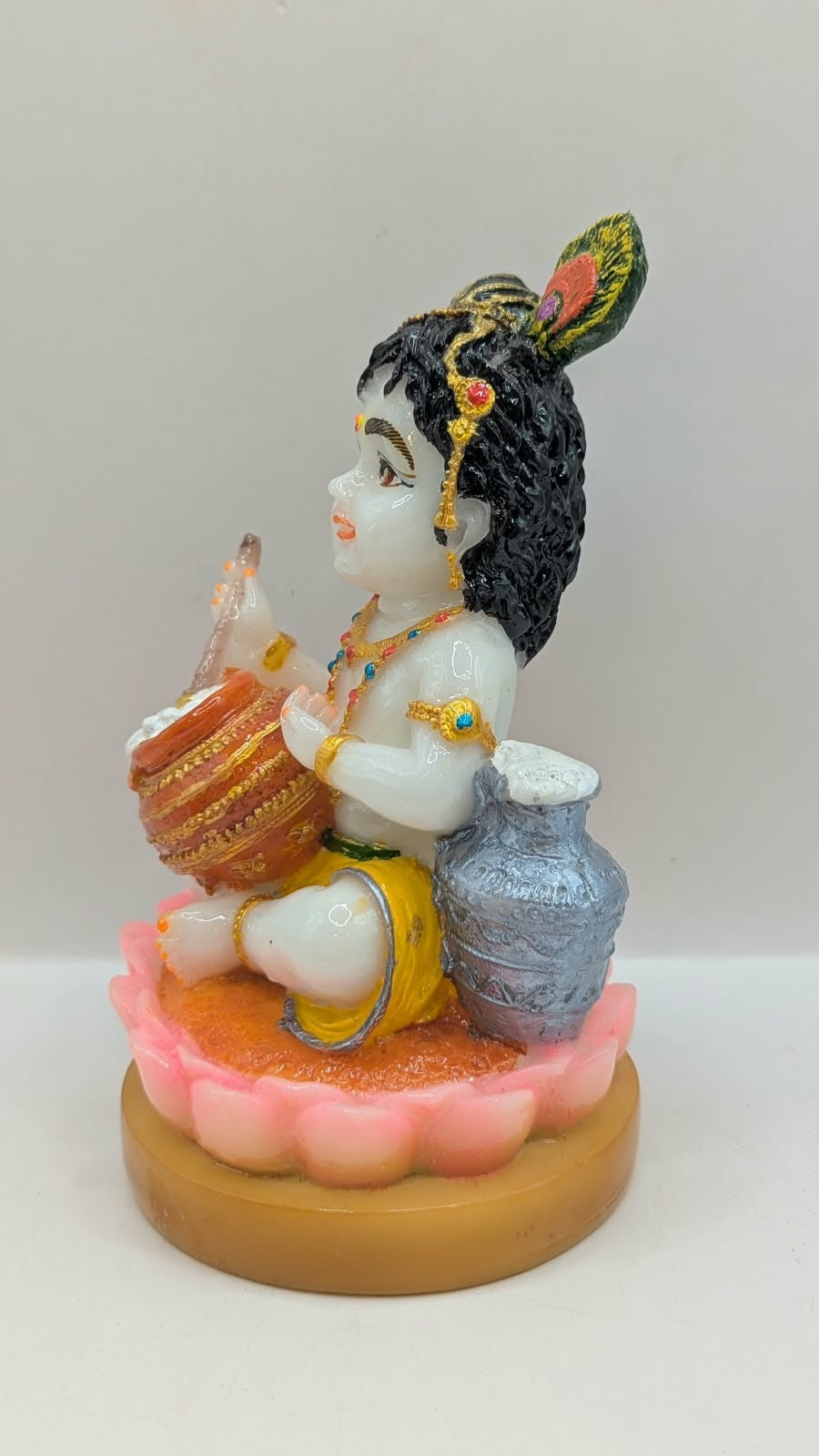White baby Krishna statue on pink lotus, other side view