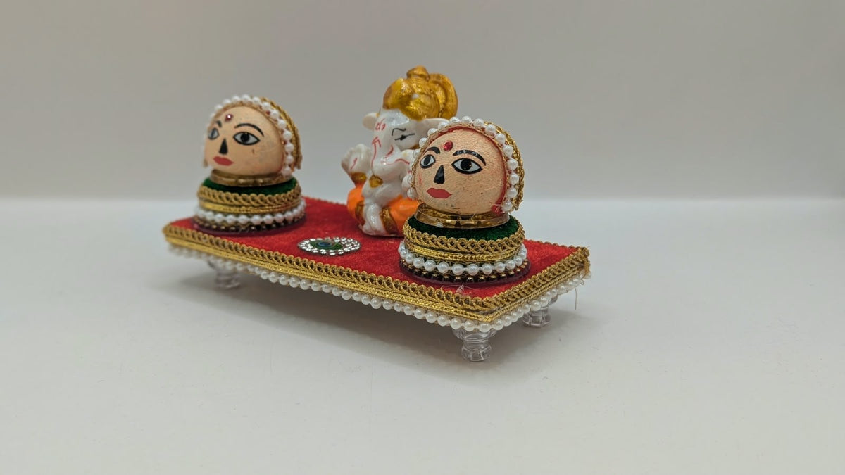 Ganesh Riddhi Siddhi set on red chowki, side view