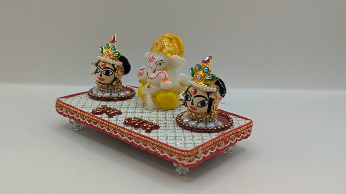 Ganesh Riddhi Siddhi set on white chowki, side view