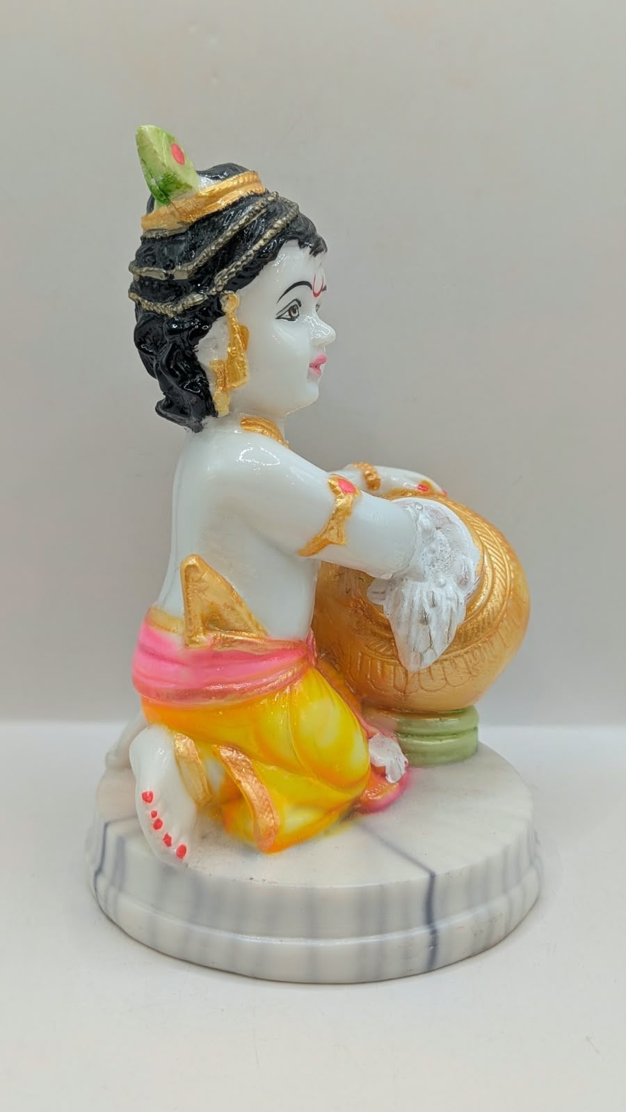 Baby Krishna statue hugging gold pot, other side view