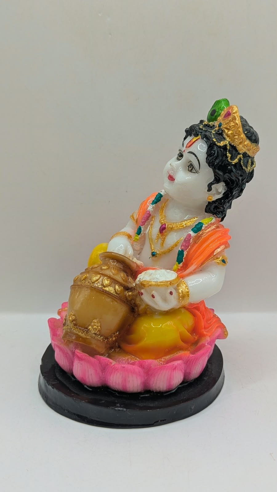 Baby Krishna statue on pink lotus, black base, other side view