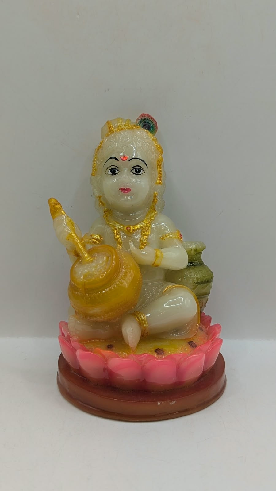 Cream and gold baby Krishna statue on lotus, front view
