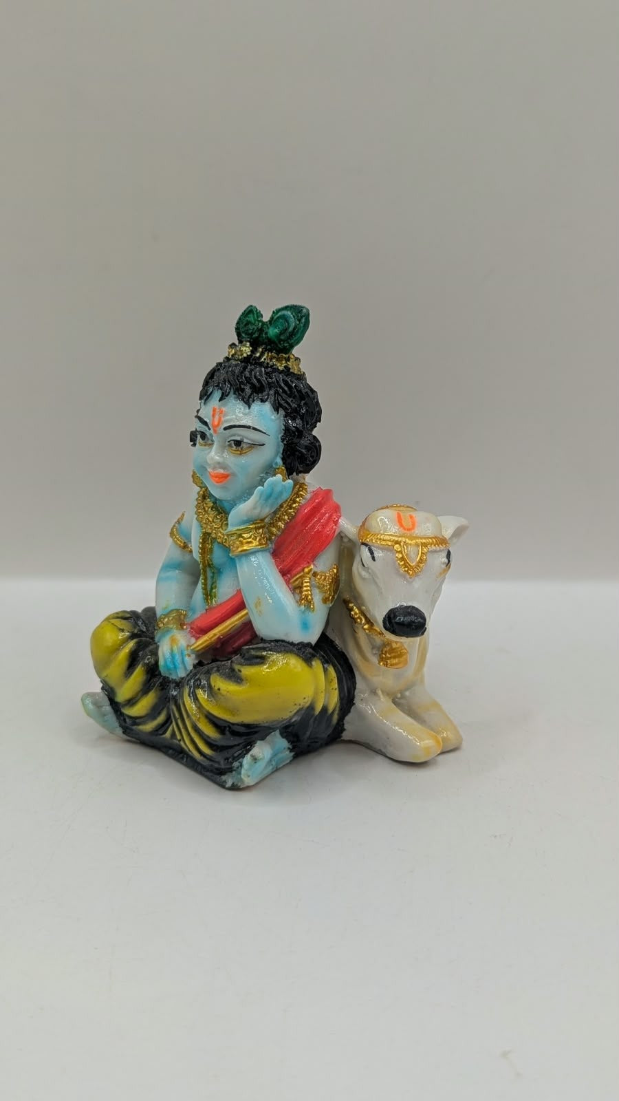 Krishna with cow statue, side view