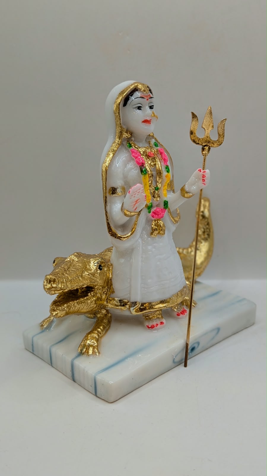 White and gold Khodiyar Maa statue, side view