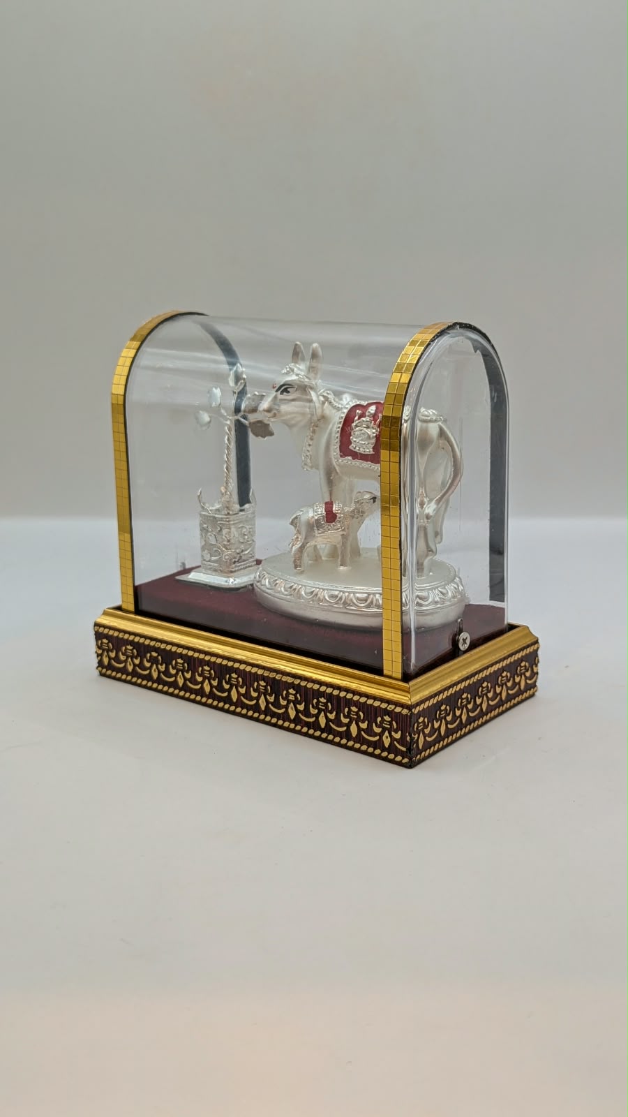 Silver Kamdhenu cow and calf in clear case, other side view