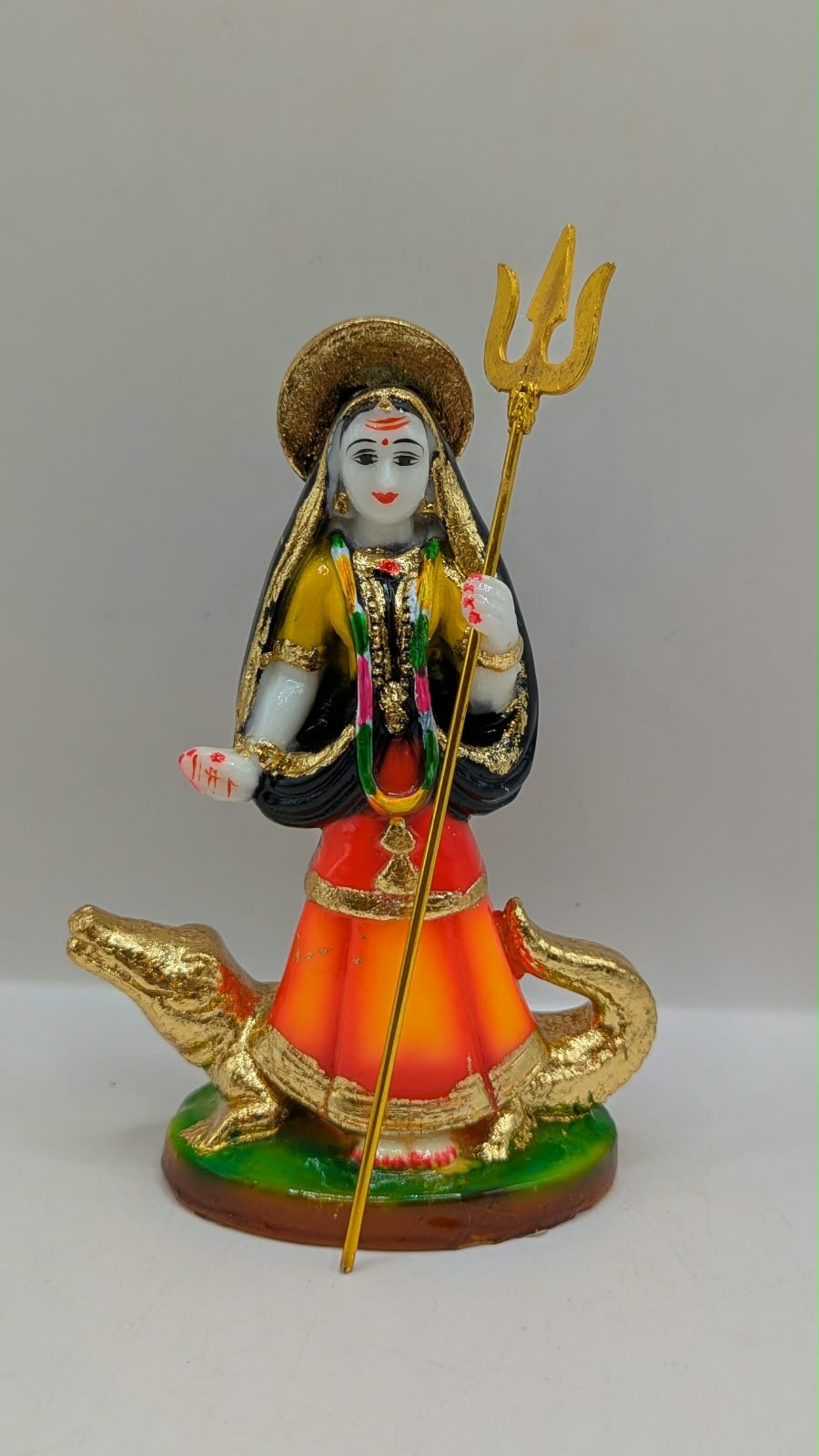 Orange and black Khodiyar Maa statue, front view