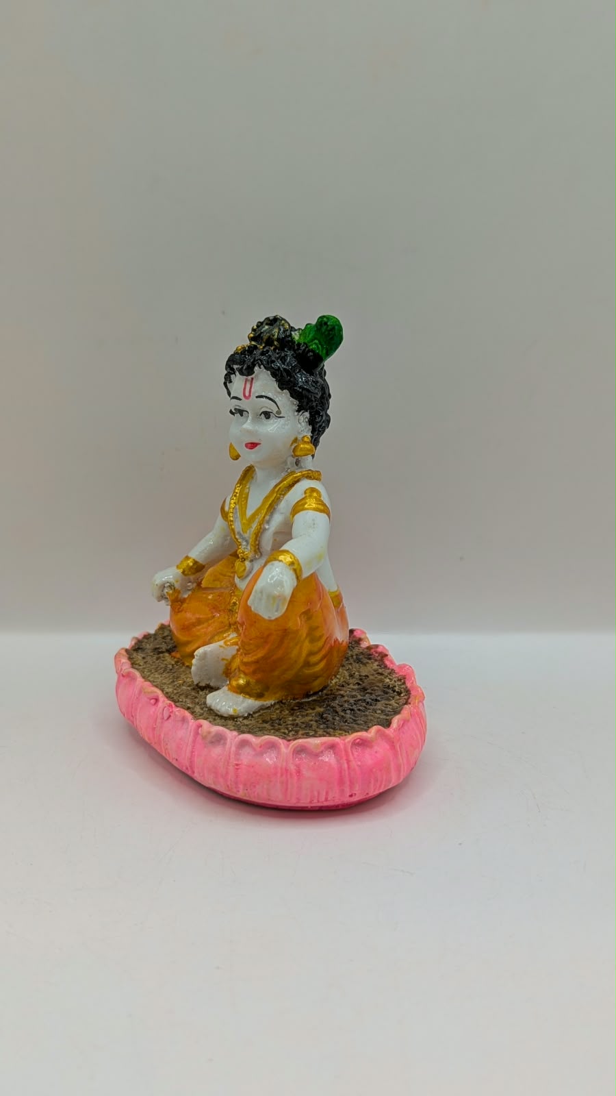 Baby Krishna statue on pink lotus, other side view