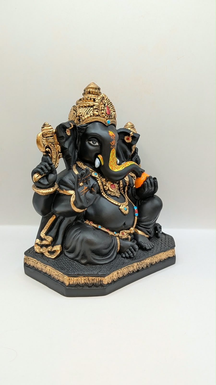 Black and gold Ganesh statue, side view
