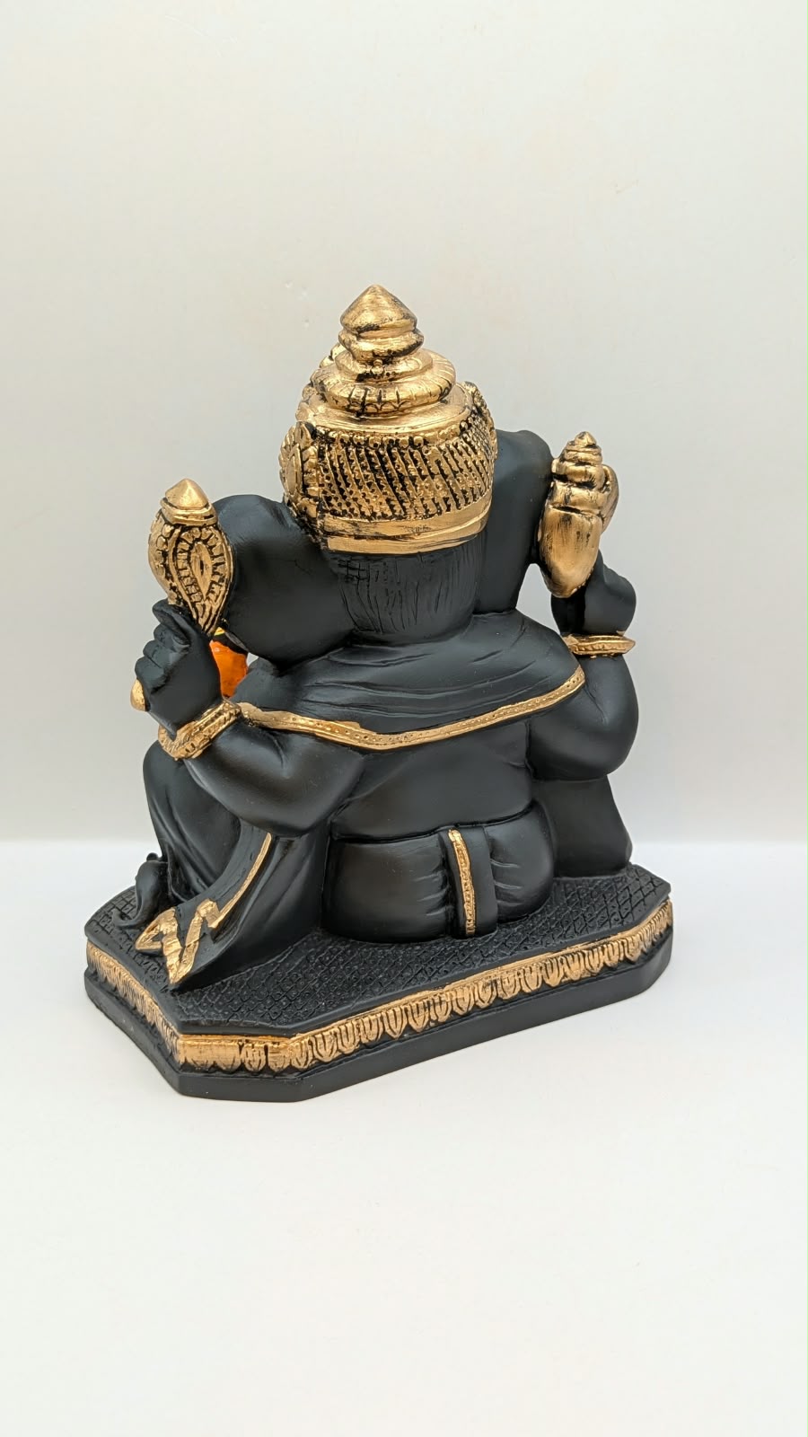 Black and gold Ganesh statue, back view