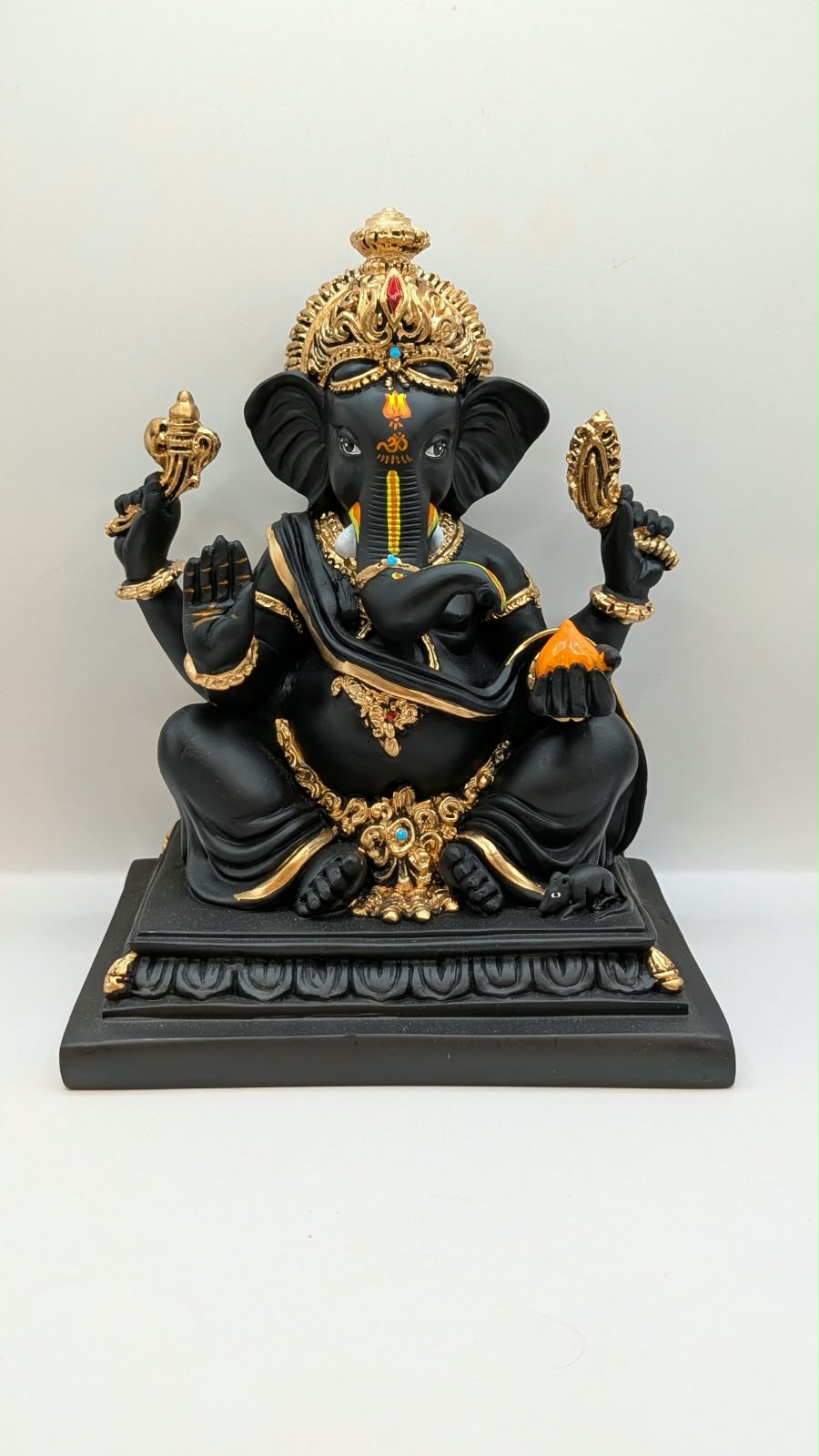 Black Ganesh on square base, front view