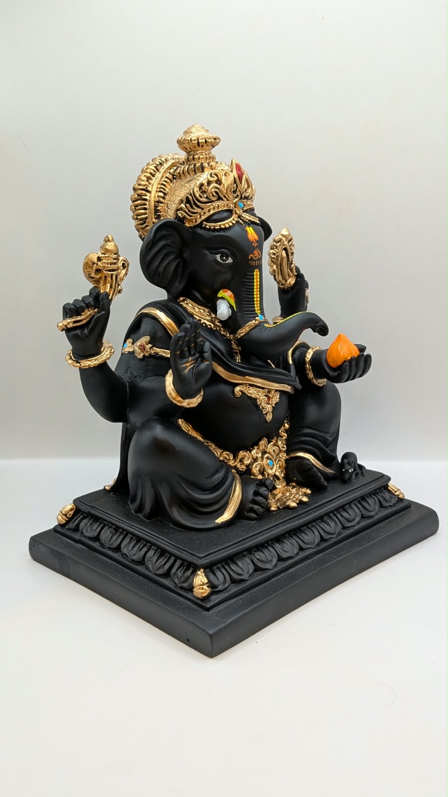 Black Ganesh on square base, side view